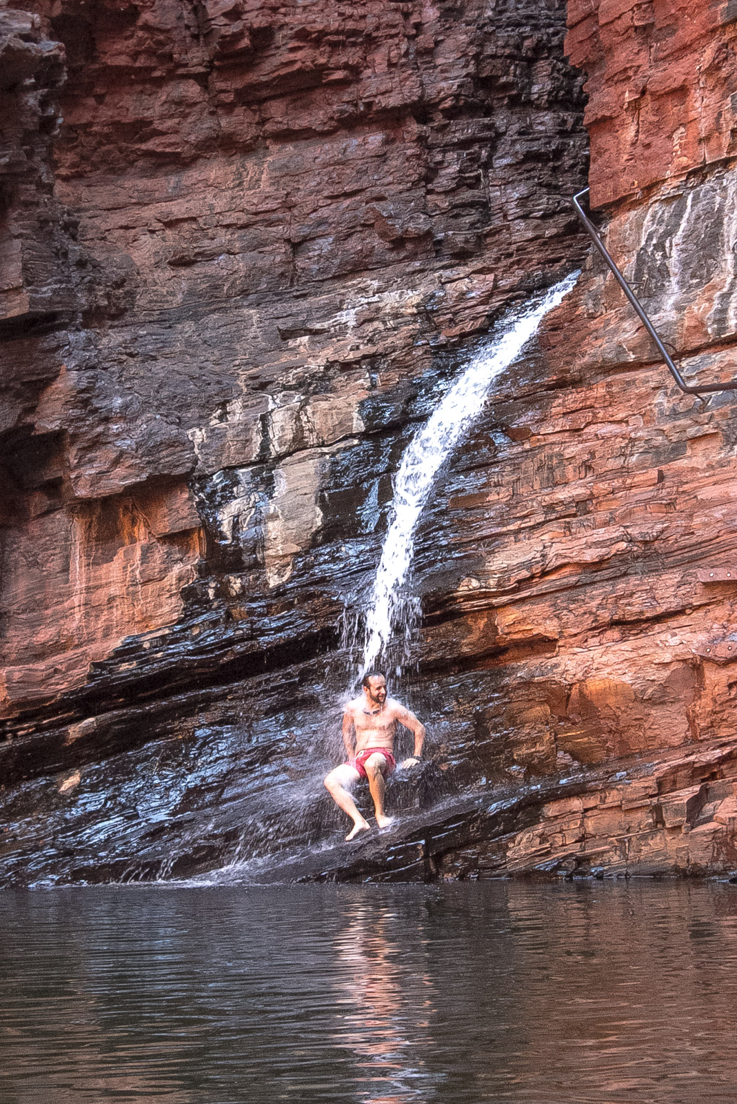 mike sat under a waterfall